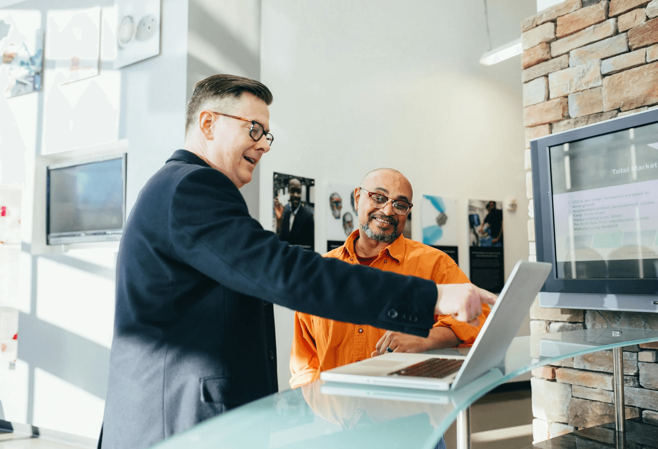 Two people reviewing offers at a laptop